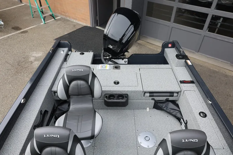 Slide: The Image of 2026 Lund 1775 Adventure Sport boat interior with gray seating and motor. - 18