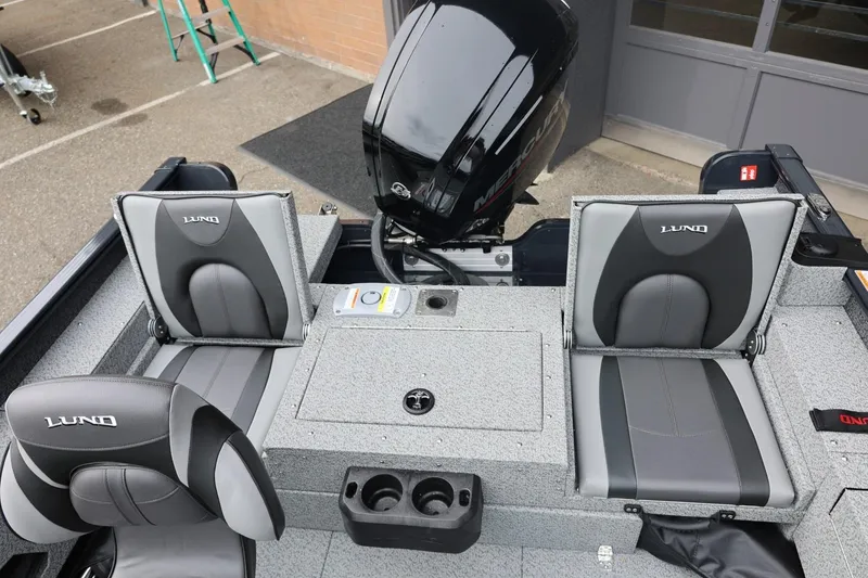Slide: The Image of 2026 Lund 1775 Adventure Sport boat interior with seating and motor, showcasing modern design. - 19