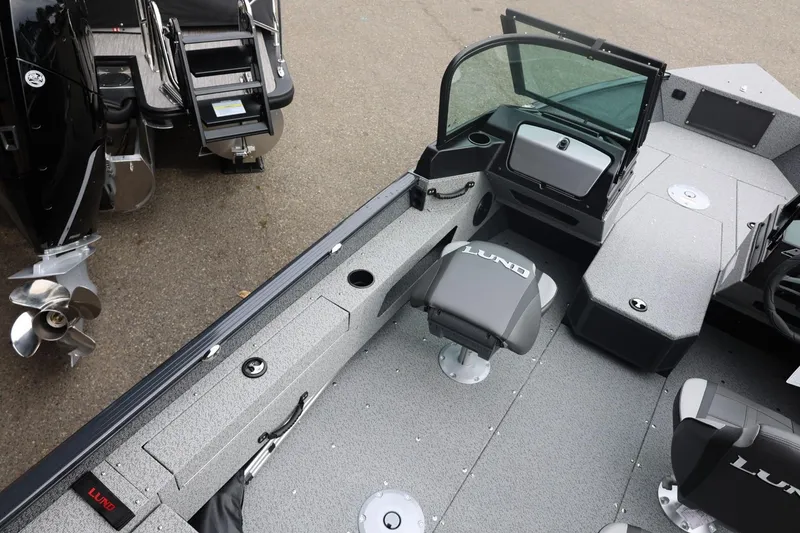 Slide: The Image of 2026 Lund 1775 Adventure Sport boat interior with seating and motor details. - 22