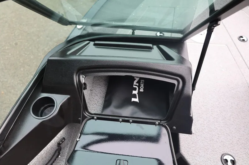 Slide: The Image of 2026 Lund 1775 Adventure Sport boat interior with storage compartment and cup holder. - 26