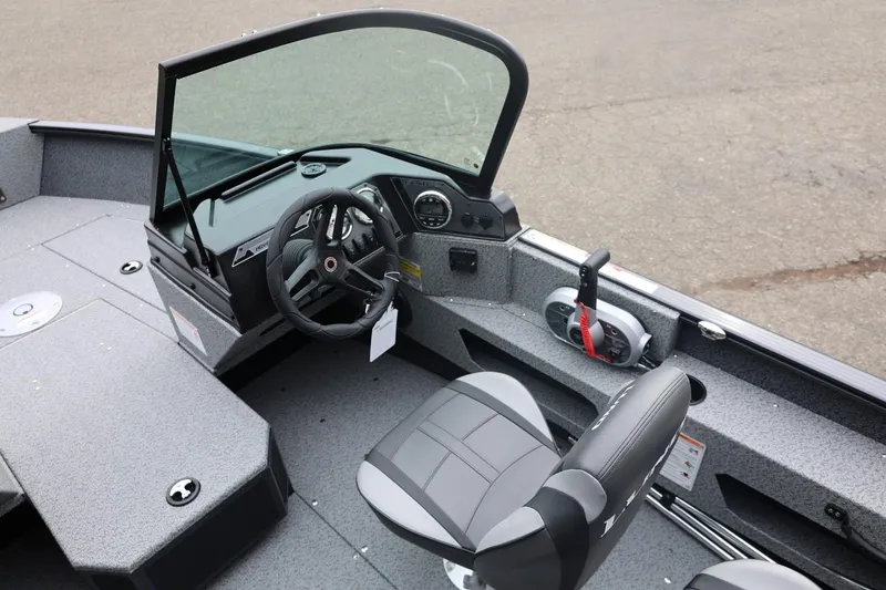 Slide: The Image of 2026 Lund 1775 Adventure Sport boat interior with steering wheel and seating. - 27