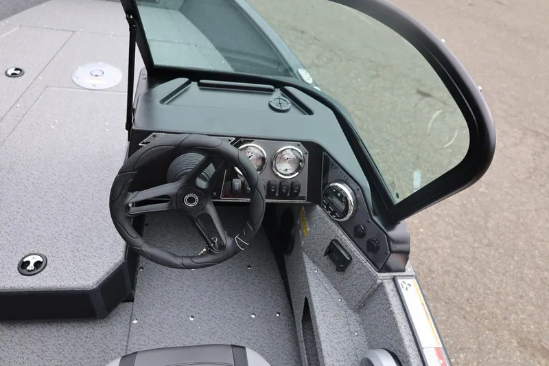 Slide: The Image of 2026 Lund 1775 Adventure Sport boat dashboard with steering wheel and gauges. - 28