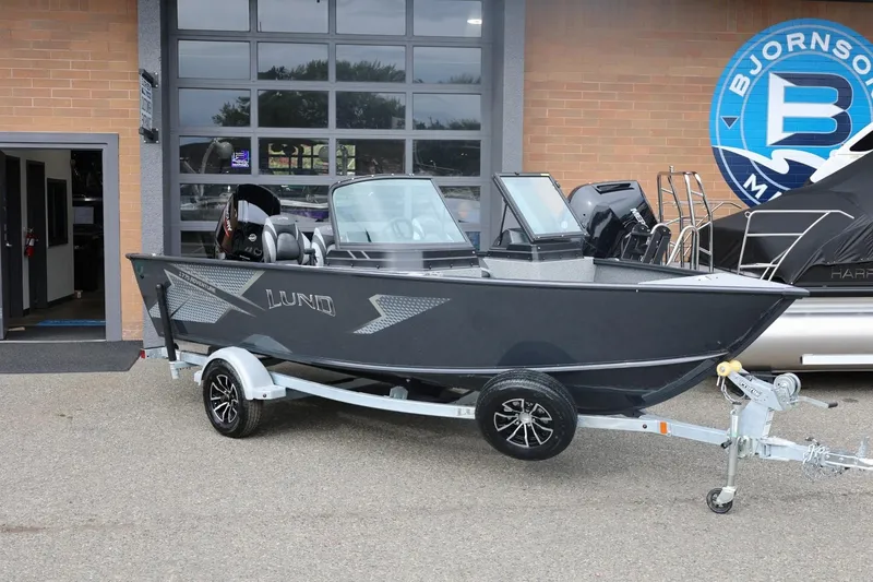 Slide: The Image of 2026 Lund 1775 Adventure Sport boat on trailer outside dealership. - 3