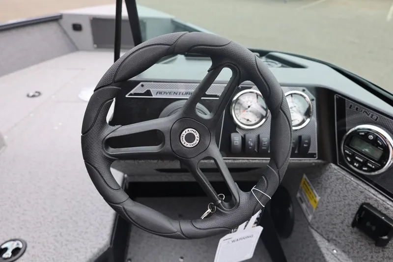 Slide: The Image of 2026 Lund 1775 Adventure Sport boat steering wheel and dashboard controls. - 32