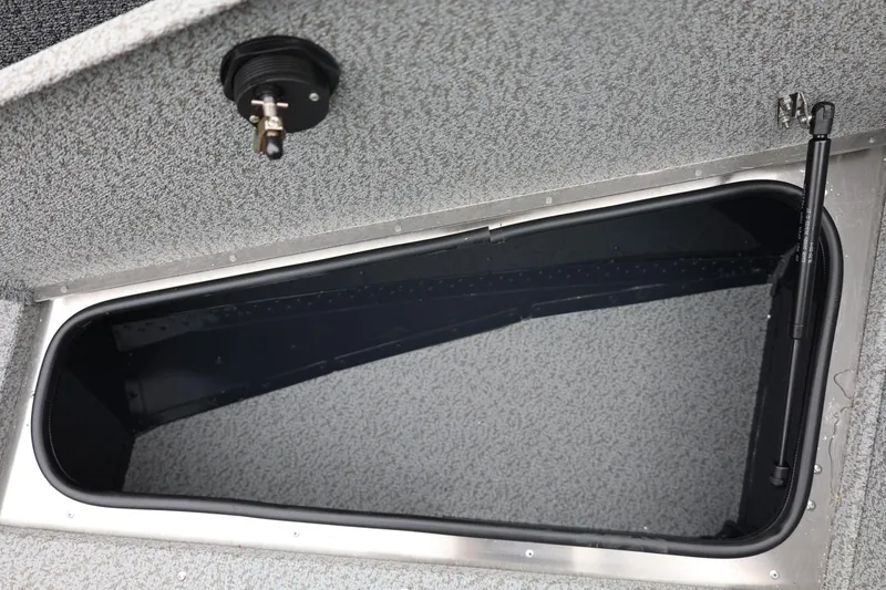 Slide: The Image of Storage compartment of 2026 Lund 1775 Adventure Sport boat, featuring a secure latch. - 41