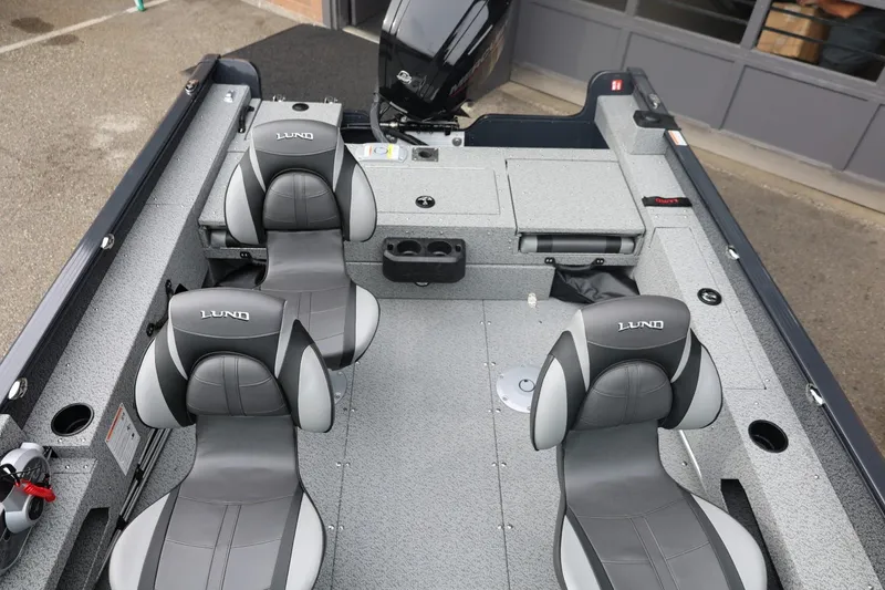 Slide: The Image of 2026 Lund 1775 Adventure Sport boat interior with gray seating and storage compartments. - 44