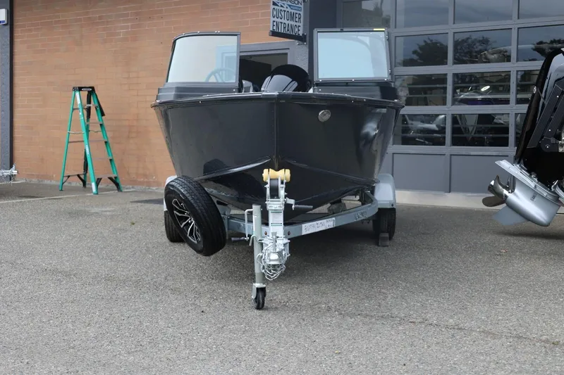 Slide: The Image of 2026 Lund 1775 Adventure Sport boat on trailer, parked outside a garage. - 6