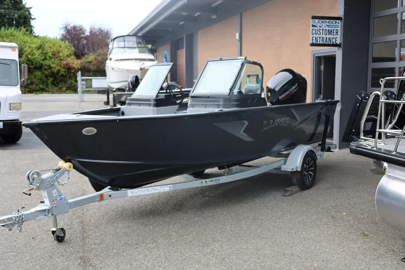 Slide: The Image of 2026 Lund 1775 Adventure Sport boat on trailer outside dealership. - 7