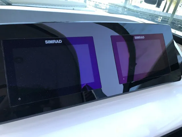 Slide: The Image of Simrad displays on 2019 Sea Ray 310 SLX boat dashboard. - 16