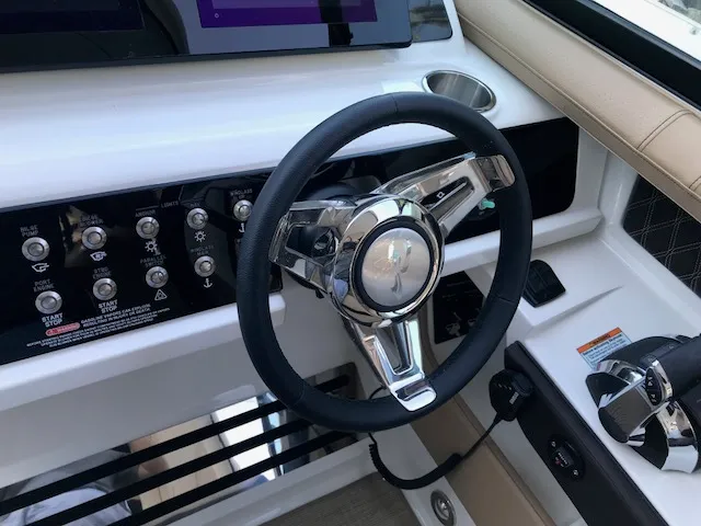 Slide: The Image of Steering wheel and controls of 2019 Sea Ray 310 SLX boat cockpit. - 17