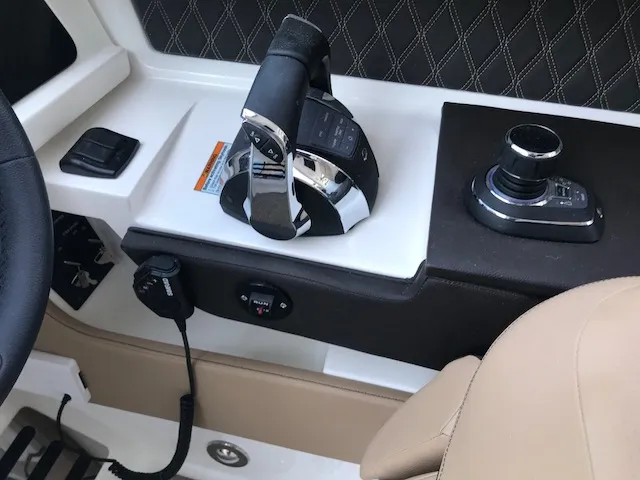 Slide: The Image of Control panel of a 2019 Sea Ray 310 SLX boat with throttle and joystick. - 19