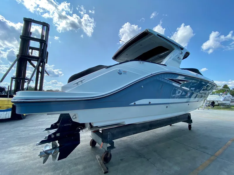 Slide: The Image of 2019 Sea Ray 310 SLX boat on display under a clear blue sky. - 2