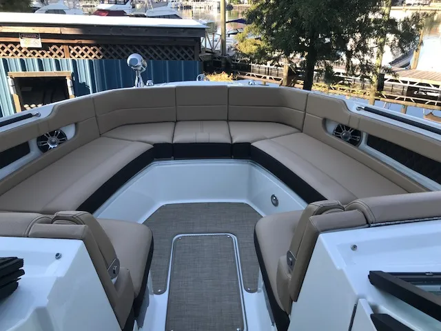 Slide: The Image of 2019 Sea Ray 310 SLX boat with spacious tan seating and modern design. - 20
