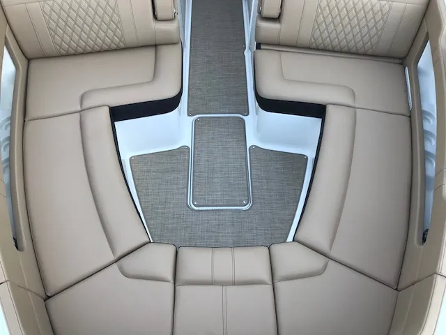 Slide: The Image of Luxurious seating area on a 2019 Sea Ray 310 SLX boat, featuring beige upholstery. - 22