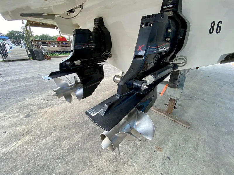 Slide: The Image of 2019 Sea Ray 310 SLX boat with dual MerCruiser outdrives on a concrete surface. - 27