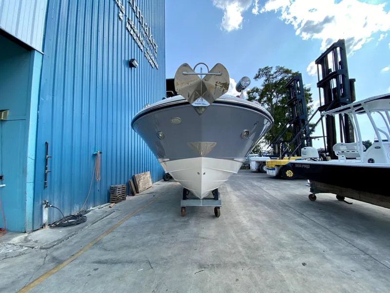 Slide: The Image of 2019 Sea Ray 310 SLX boat in a marina storage area, front view. - 3