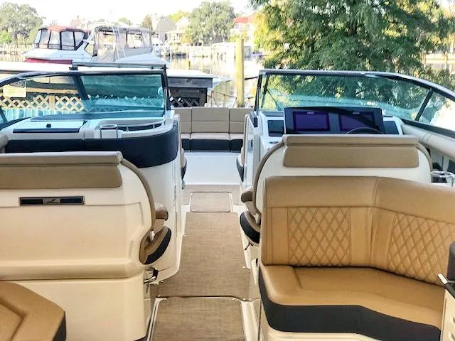 Slide: The Image of 2019 Sea Ray 310 SLX boat interior with tan seating and modern dashboard. - 5