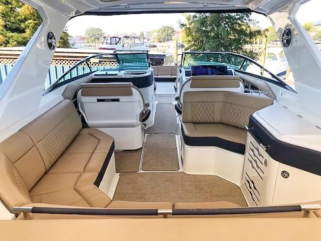 Slide: The Image of 2019 Sea Ray 310 SLX boat interior with tan seating and modern design. - 6