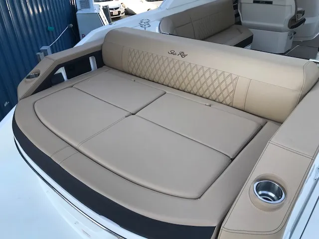 Slide: The Image of 2019 Sea Ray 310 SLX boat with beige leather seating and cup holders. - 7