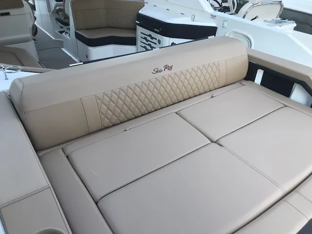 Slide: The Image of 2019 Sea Ray 310 SLX boat interior with beige seating and diamond stitching. - 8