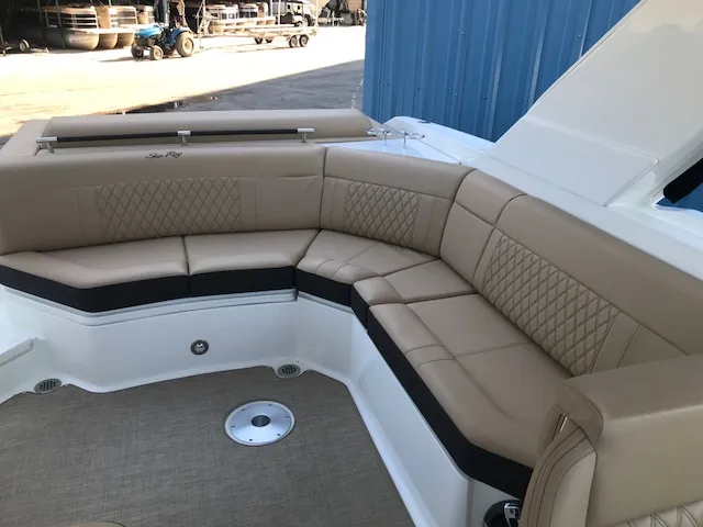 Slide: The Image of 2019 Sea Ray 310 SLX boat with luxurious tan seating and elegant design. - 9