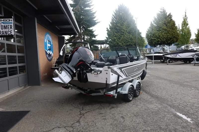Slide: The Image of 2026 Lund 1875 Impact XS Sport boat parked outside dealership. - 15