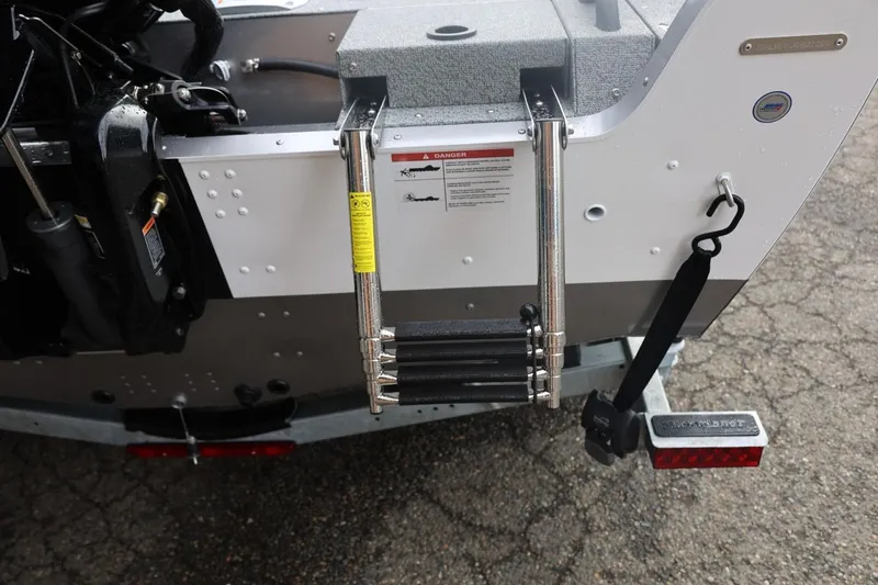 Slide: The Image of 2026 Lund 1875 Impact XS Sport boat ladder and rear details. - 18