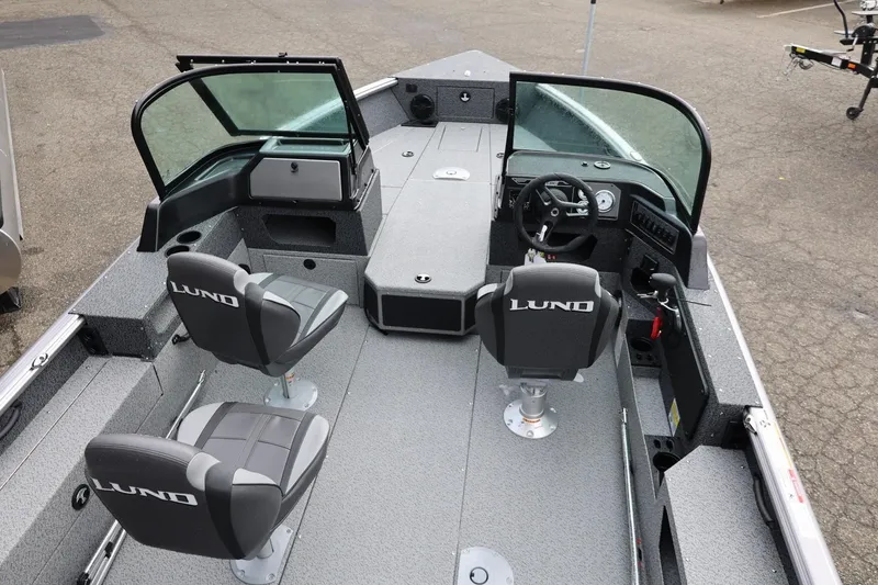 Slide: The Image of 2026 Lund 1875 Impact XS Sport boat interior with seating and steering console. - 19