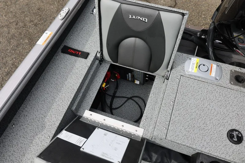 Slide: The Image of 2026 Lund 1875 Impact XS Sport boat interior with storage compartment open. - 22