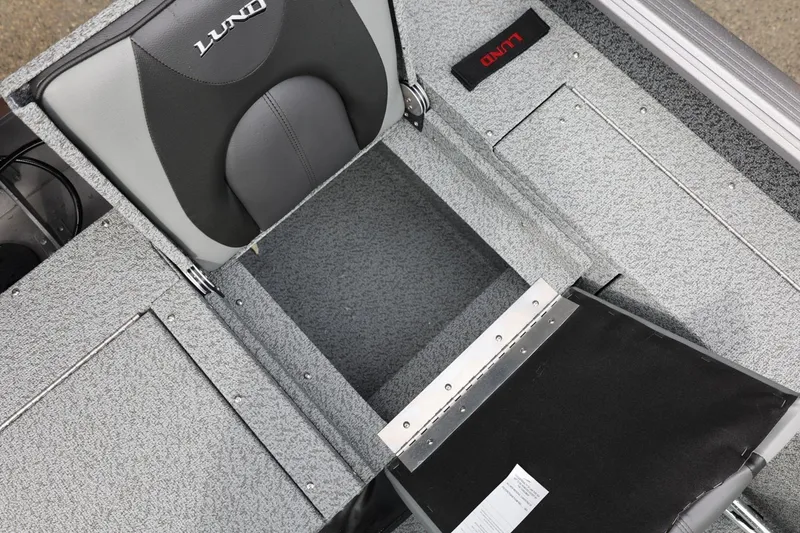 Slide: The Image of 2026 Lund 1875 Impact XS Sport boat interior with storage compartment and seating. - 23