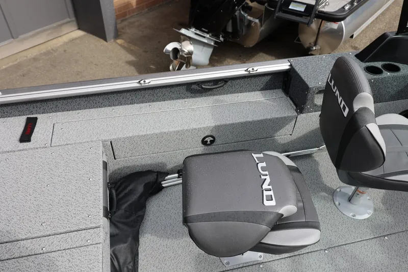 Slide: The Image of 2026 Lund 1875 Impact XS Sport boat interior with branded seats and storage compartments. - 25