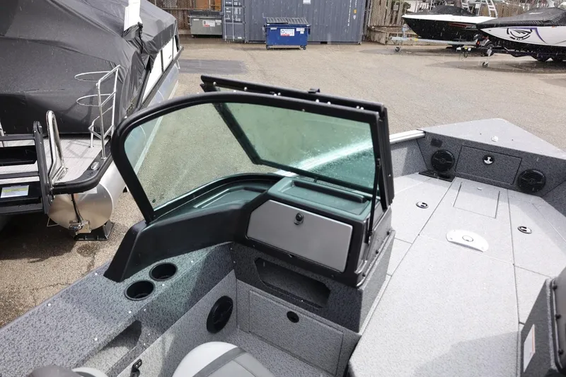 Slide: The Image of 2026 Lund 1875 Impact XS Sport boat interior with windshield and seating area. - 32