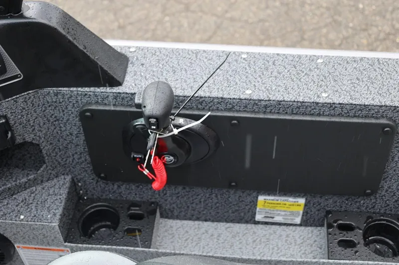 Slide: The Image of 2026 Lund 1875 Impact XS Sport boat control panel with throttle and safety lanyard. - 35