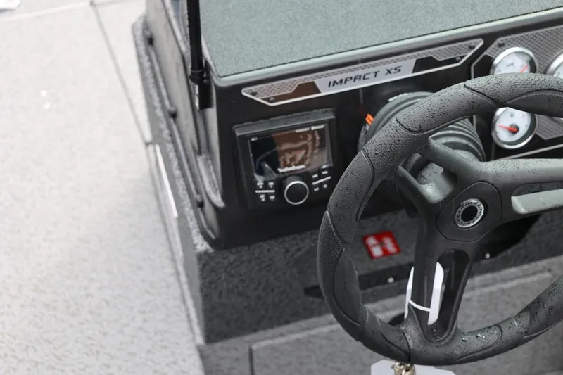 Slide: The Image of 2026 Lund 1875 Impact XS Sport dashboard with steering wheel and controls. - 37