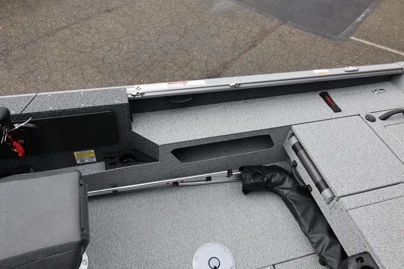 Slide: The Image of 2026 Lund 1875 Impact XS Sport boat interior with seating and storage compartments. - 38