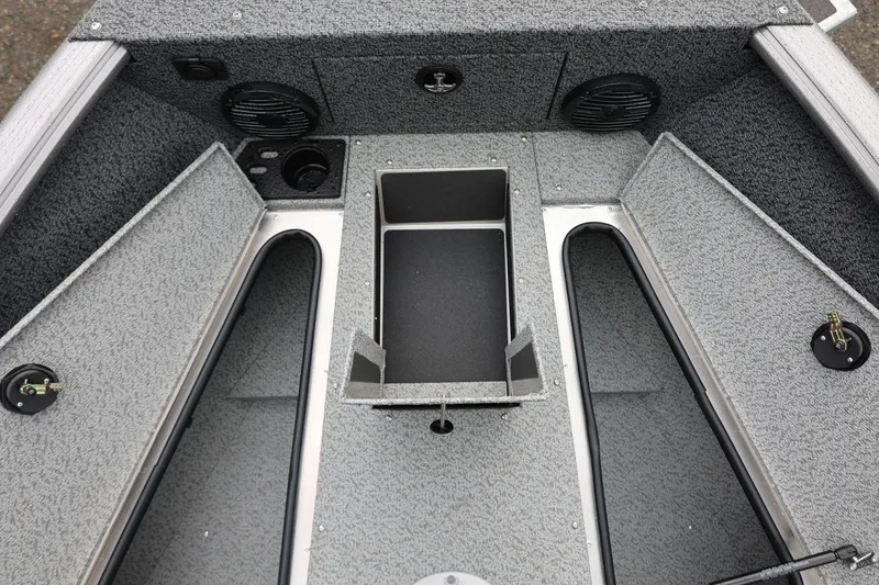 Slide: The Image of 2026 Lund 1875 Impact XS Sport boat interior with storage compartments and speakers. - 49