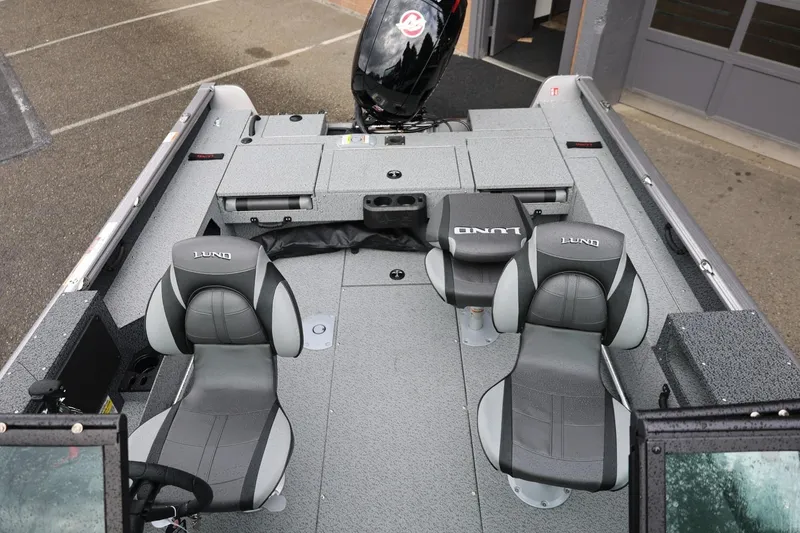 Slide: The Image of 2026 Lund 1875 Impact XS Sport boat interior with gray seating and storage compartments. - 54