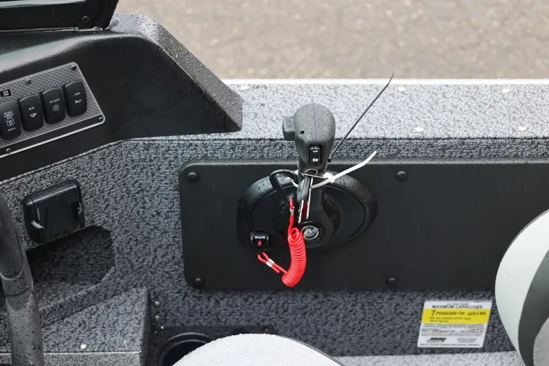 Slide: The Image of 2026 Lund 1875 Impact XS Sport boat interior with control panel and throttle. - 55