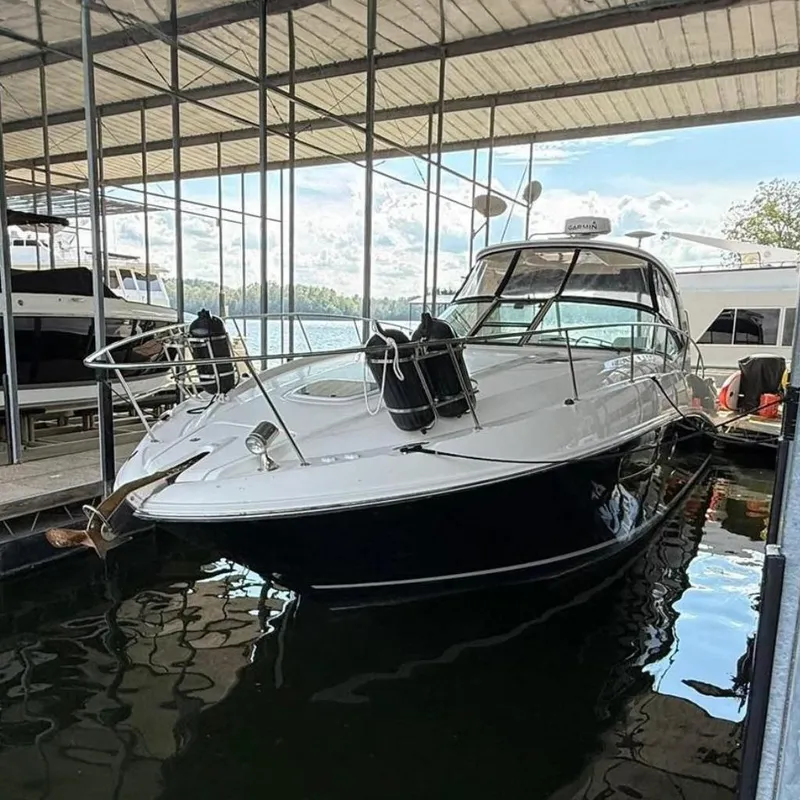 Slide: The Image of 2009 Sea Ray 350 Sundancer docked in a marina under a covered structure. - 1
