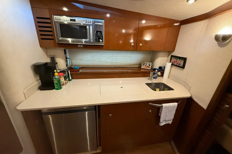 Slide: The Image of 2009 Sea Ray 350 Sundancer yacht kitchen with modern appliances and sleek cabinetry. - 14