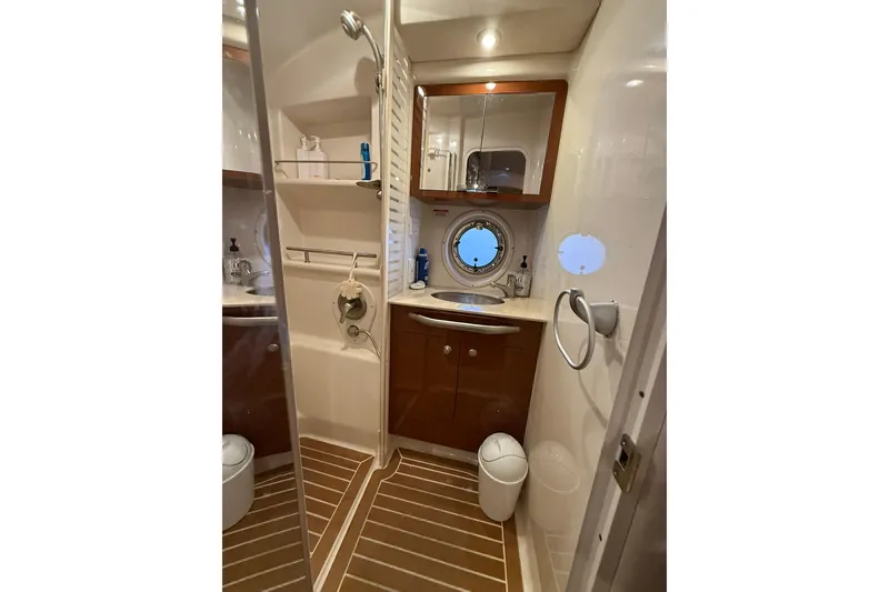 Slide: The Image of Luxurious bathroom in 2009 Sea Ray 350 Sundancer yacht with modern fixtures and porthole window. - 17