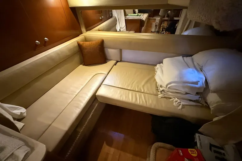 Slide: The Image of Interior of 2009 Sea Ray 350 Sundancer with beige seating and cozy cushions. - 20