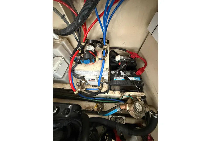 Slide: The Image of Engine compartment of a 2009 Sea Ray 350 Sundancer with visible wiring and components. - 24