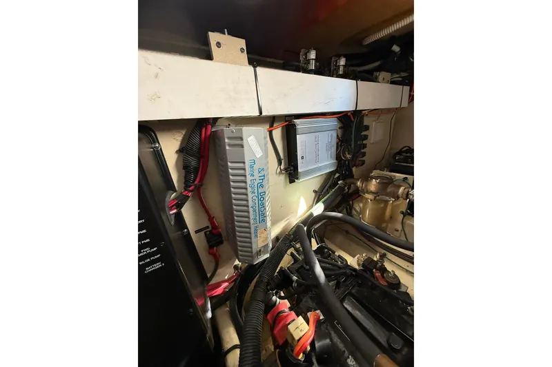 Slide: The Image of Engine compartment of 2009 Sea Ray 350 Sundancer with marine components and wiring. - 25