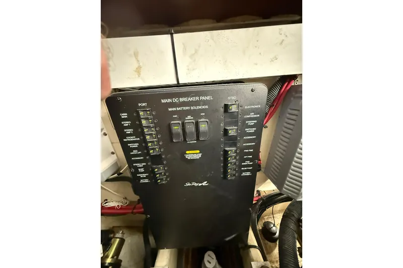 Slide: The Image of Main DC breaker panel on 2009 Sea Ray 350 Sundancer boat, featuring various switches and controls. - 26