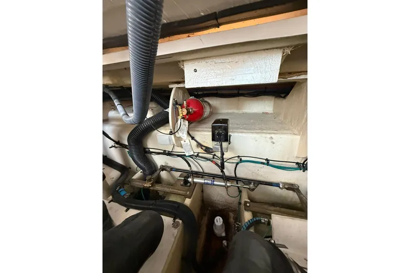 Slide: The Image of Engine compartment of a 2009 Sea Ray 350 Sundancer with hoses and wiring visible. - 30