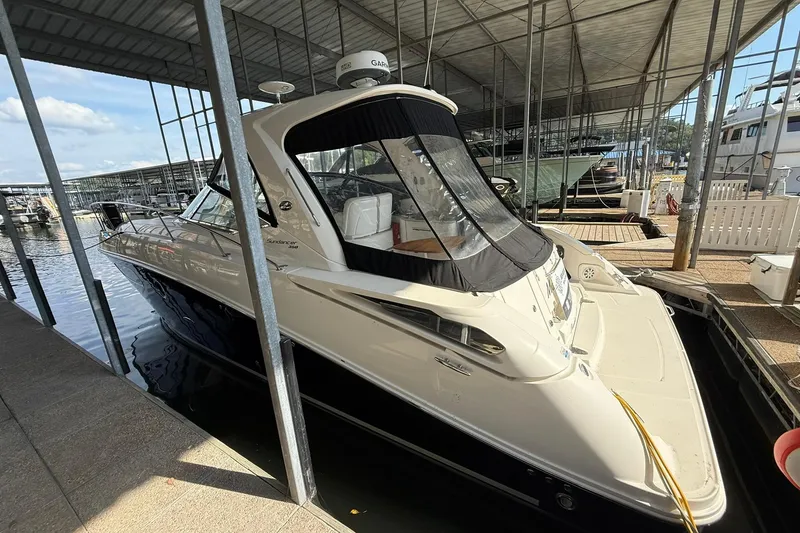 Slide: The Image of 2009 Sea Ray 350 Sundancer docked in a covered marina, side view. - 4