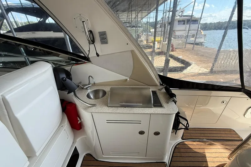Slide: The Image of 2009 Sea Ray 350 Sundancer boat interior with kitchenette and lake view. - 8
