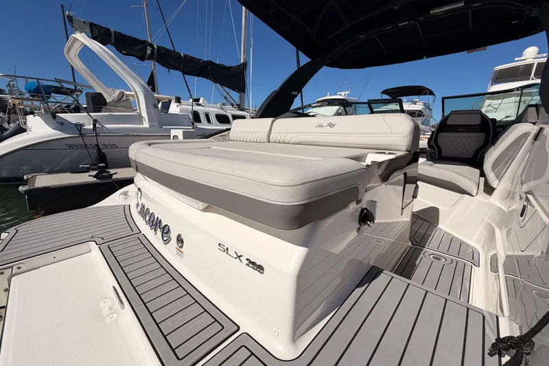 Slide: The Image of 2024 Sea Ray SLX 260 boat interior with luxurious seating at marina. - 11