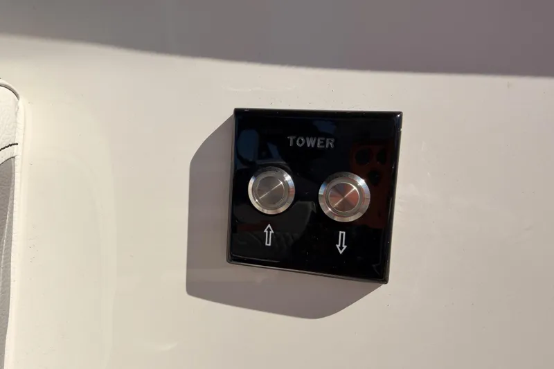 Slide: The Image of Control panel on 2024 Sea Ray SLX 260 boat, featuring tower adjustment buttons. - 16